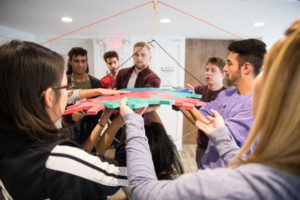 Students collaborating on a bridge.