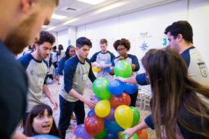 Students working on an exercise involving balloons.