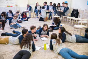 Students lying on the group chatting.