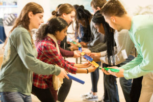 Students working together to build a bridge.